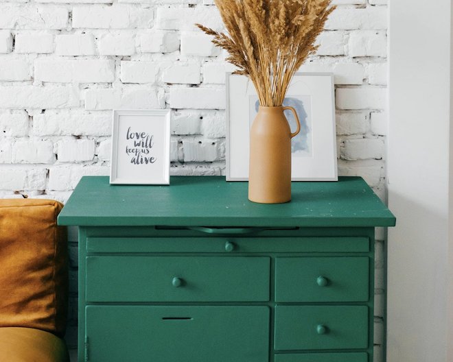 a flower vase on a drawer